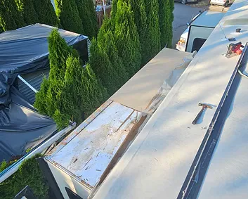 RV roof with resealed seams and patched sections after a roof repair in Arlington, WA